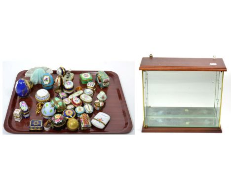A collection of ceramic eggs and boxes with small display case 