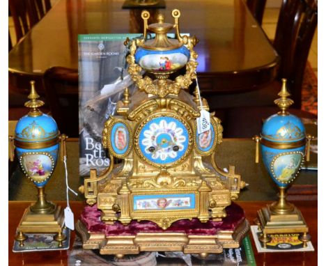 A French gilt metal and porcelain mounted clock garniture, late 19th century, on gilt wood stand