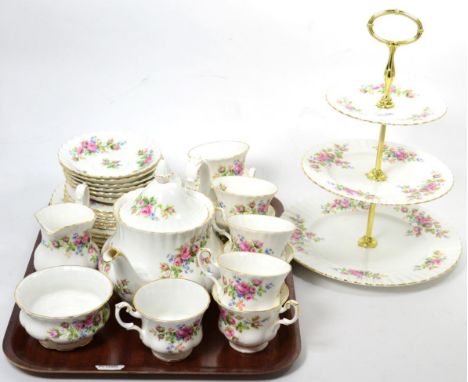 A part Royal Albert 'Moss Rose' pattern teaset comprising nine cups, six saucers, six side plates, six plates, teapot, cream 