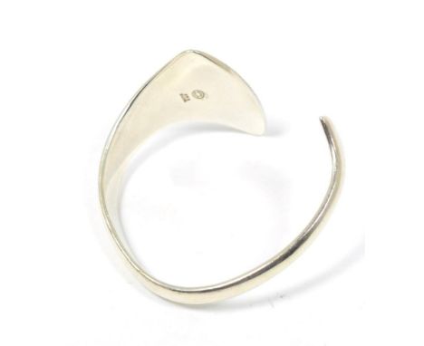 A Georg Jensen 'Peak' bangle, designed by Bent Gabrielsen, terminating in graduated triangular motifs, measures 6cm by 5.5cm 