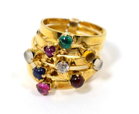 A multi-gemstone stacking ring, of five bands each set with a cabochon, including emerald, citrine, paste, moonstone, ruby an