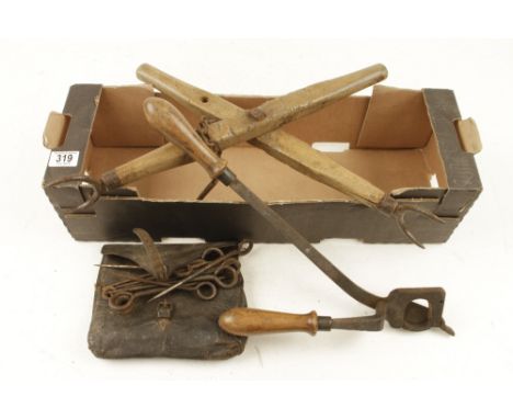 A horse tail docker , leather bag with steel pegs and another tool G 