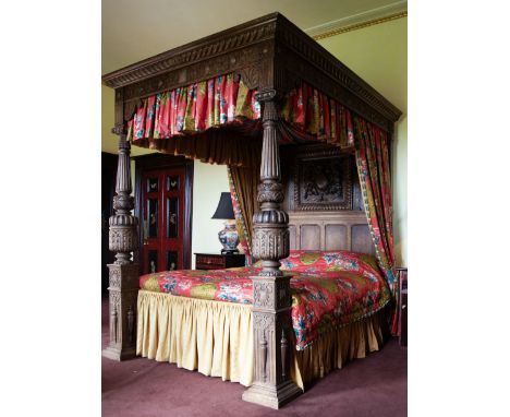 Elizabethan design oak 5' Kingsize four-poster bed, the canopy with projecting moulded and gadrooned cornice over applied str