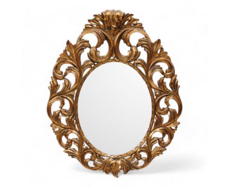 Florentine design gilt wall mirror, bevelled oval mirror plate surrounded by scrolling and interlaced acanthus leaves, curled