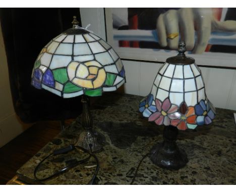 A Tiffany style bronzed table lamp with lidded coloured glass shade. H.40, together with other Tiffany style table lamp. H.33