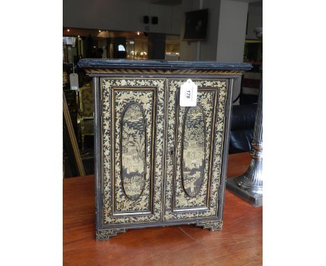 A late 19th / early 20th century chinoiserie table cabinet, having a moulded top above a pair of fielded panel cupboard doors