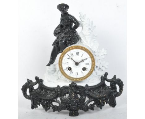 A vintage early 20th Century mantle clock in a black and white colour way. With a person sat atop the dial in regency dress w