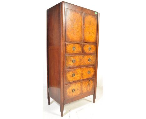 An early 20th century Edwardian circa. 1900's burr walnut cabinet having twin doors opening to reveal shelved interior over a