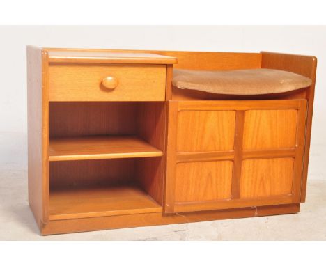 A retro vintage mid 20th century teak wood telephone table having a cushioned seat to the right and single drawer to the left