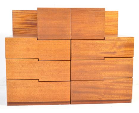A pair of vintage retro mid 20th century teak wood bedside cabinets having two drawers with pigeon hole, raised upon a block 