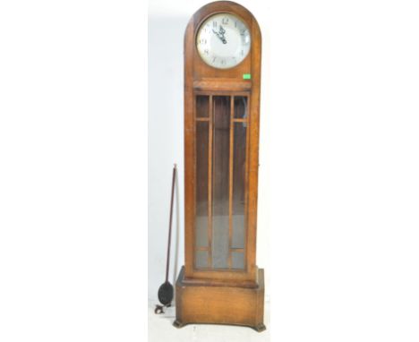 A vintage 20th century oak grandfather clock having a dome top, brushed steel clock face with Arabic numerals to the chapter 