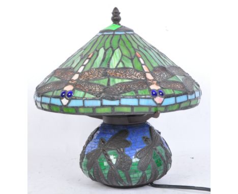 A vintage 20th century Tiffany style stained glass and leaded table lamp having dragonflies to shade and base.&nbsp;