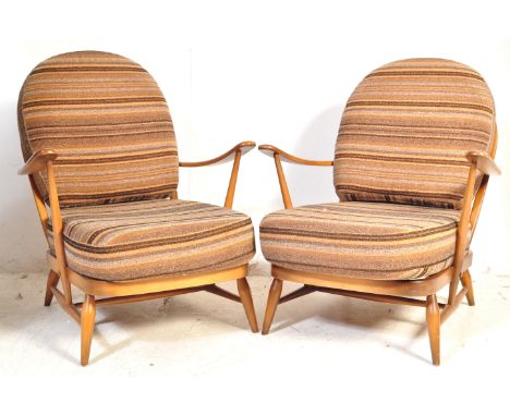 Ercol - A vintage mid 20th century Windsor pattern beech and elm wood pair of armchairs complete with the original upholstery