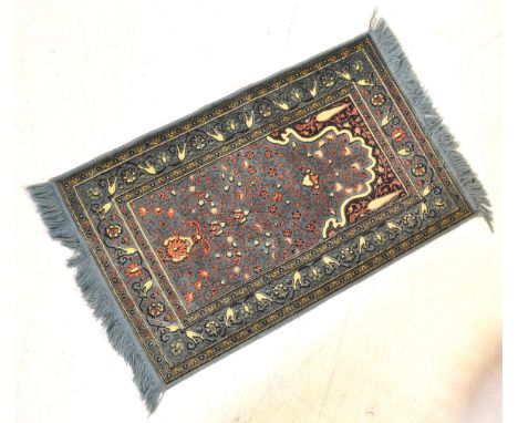 A vintage 20th century Persian Tabriz style rug carpet having a blue ground with foliate detail and bouquet and urn pattern w