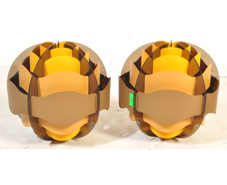 A pair of retro vintage 20th century light shades of globular form having vented stylised decoration in a yellow and brown co
