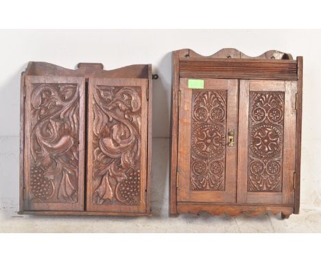 Two Victorian 19th Century carved oak wall hanging smokers' cabinets both having gallery backs with carved twin panel doors w