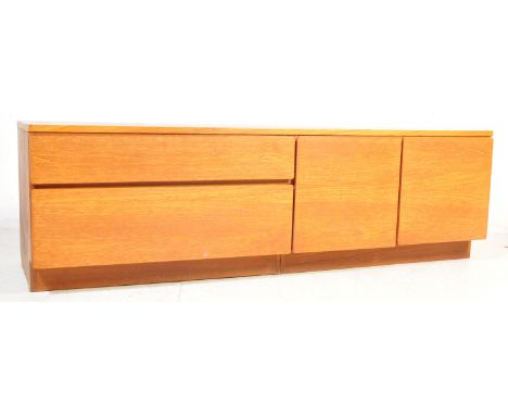 A retro vintage 20th Century c. 1970's teak low board / sideboard. Of rectangular form with a bank of two drawers to the left