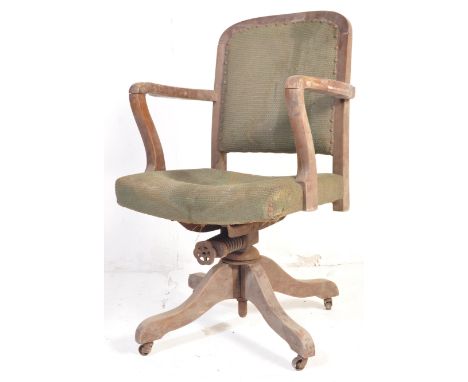 A retro vintage mid 20th Century industrial office rotating desk chair. With curved backrest, rectangular seat button upholst
