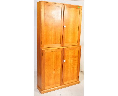 A vintage retro mid 20th century pine linen cupboard comprising of two twin door cupboards opening to reveal shelved interior