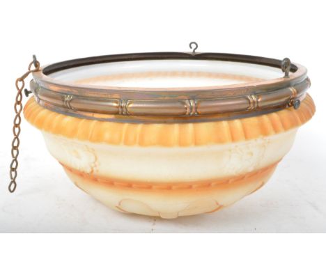A early 20th century pressed glass ceiling light shade. The light shade having moulded gadrooning and flowers to the surface 