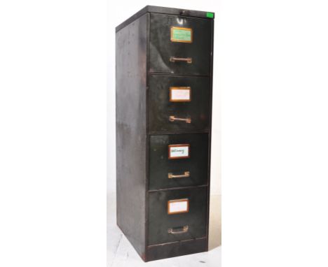 A vintage retro mid 20th century industrial style green metal filing cabinet having three drawers with brass handles and bras