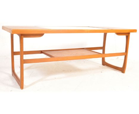 A retro mid 20th century teak wood coffee table having a central glazed panel with Quadrille manner supports united by a cent