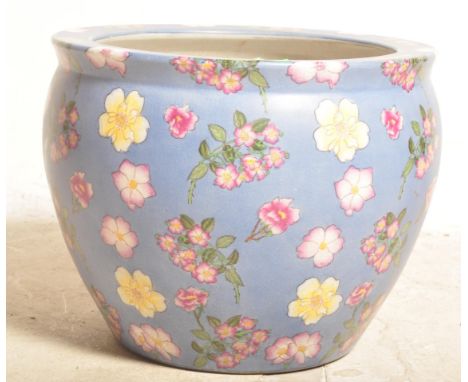 A large vintage 20th century Chinese Oriental ceramic jardinière / planter having having a pale blue ground with polychrome f