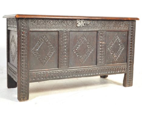 An 18th Century carved oak wood coffer / chest / trunk. Of retangular form, with a flared hinged open top to reveal a spaciou