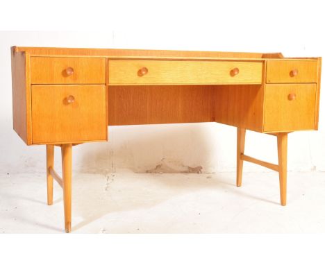 Meredew Furniture - A vintage retro mid 20tgh century circa. 1960's teak wood Meredew writing desk. The desk having a a centr