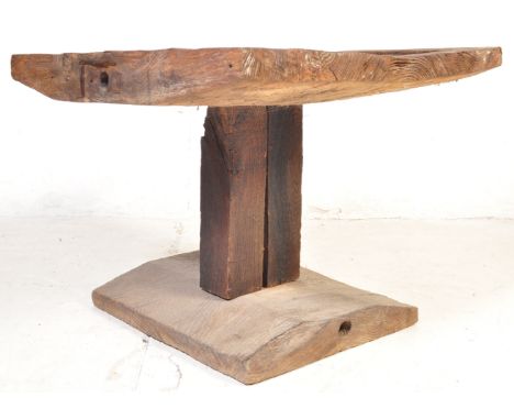 A vintage retro 20th century industrial style centre table constructed from a piece of square driftwood upon a columnar type 