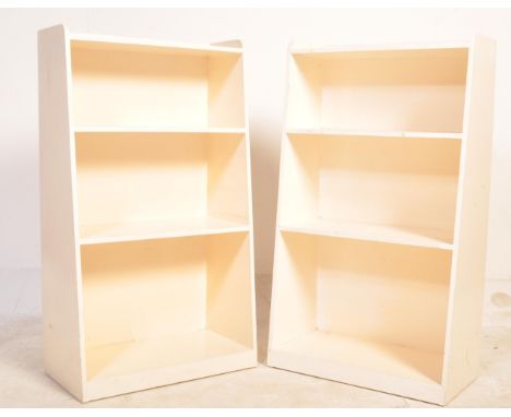 A pair of vintage 20th century open faced shelves having a stub gallery back painted in a white colourway. Measures 89cm x 51