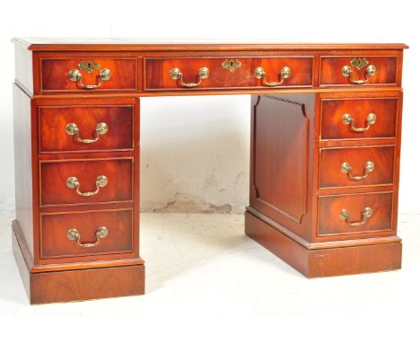 A Victorian Revival mahogany pedestal writing desk having a tri panel writing area with gilt tooling, central knee area flank