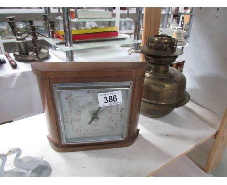 A brass oil lamp font and a barometer.