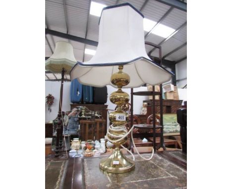 A brass table lamp with shade.