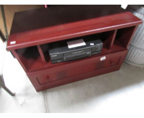 A television stand and a video recorder.