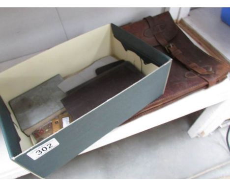An old leather briefcase and with an assortment of military ephemera including Board of Trade continuous certificate of disch