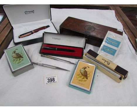 A mixed lot including Parker Pens, tie press, playing cards etc.,