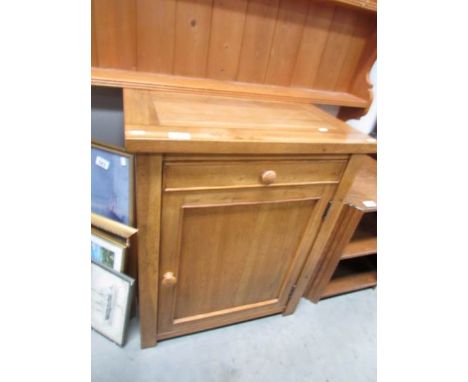 A light oak cupboard with open back,