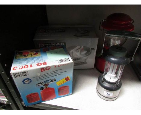 A boxed electric sander, camping stove and 2 lanterns.