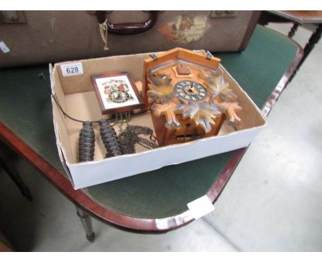 A cuckoo clock and a Hummel wall clock.
