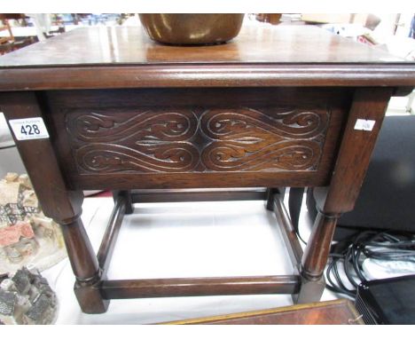 An oak storage stool.