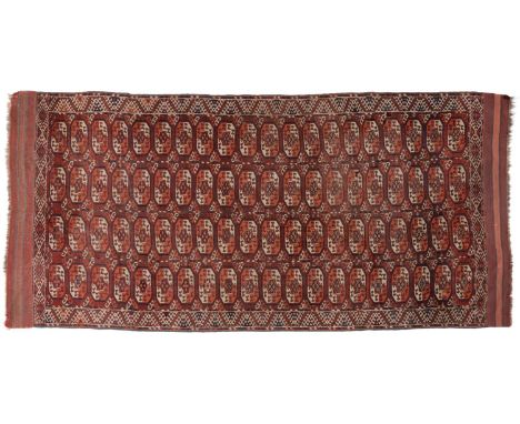 Kizil Ayak Turkmen Carpet, 19th century Emirate of Bukhara The madder field of Tauk Nuska guls enclosed by borders of stepped