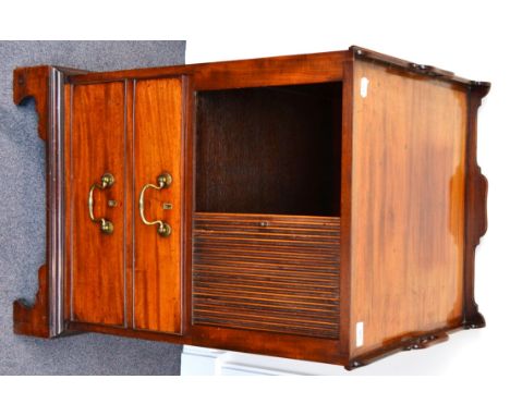 A George III Mahogany Tray Top Commode, circa 1800, the gallery top with two carrying handles above a tambour drawer, the bas