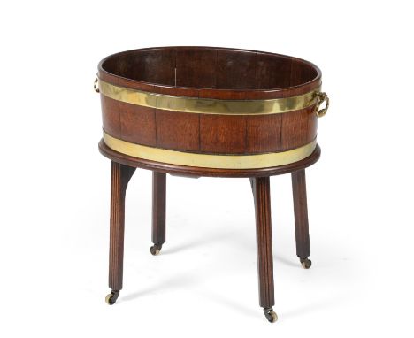 A George III Mahogany and Brass Bound Oval Cellaret, late 18th century, of staved construction with two brass rings and carry
