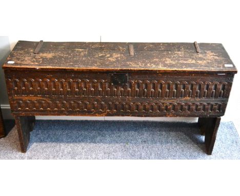 A 17th Century Boarded Oak Chest, the hinged lid above a stop-fluted carved panel, 118cm by 31cm by 58cm Plank top with varni