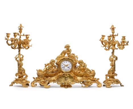 A Good Ormolu Striking Mantel Clock with Garniture, circa 1880, the elaborate case surmounted by cherubs, a goat and floral a