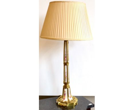 An Early Victorian Ormolu Mounted Porcelain Lamp Base, the circular weighted base with tong and dart border, the stem of upsw