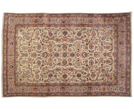 Kashan Carpet Central Persia The ivory field with an allover design of scrolling leaves enclosed by palmette borders, 395cm b