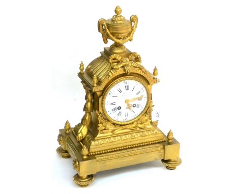 A Gilt Metal Striking Mantel Clock, retailed by Cronier, A Paris, circa 1880, elaborate case surmounted by an urn finial, bow