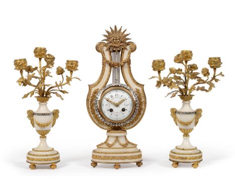 An Ormolu Mounted White Marble Striking Lyre Mantel Clock with Garniture, circa 1900, surmounted by a sun burst finial, appli